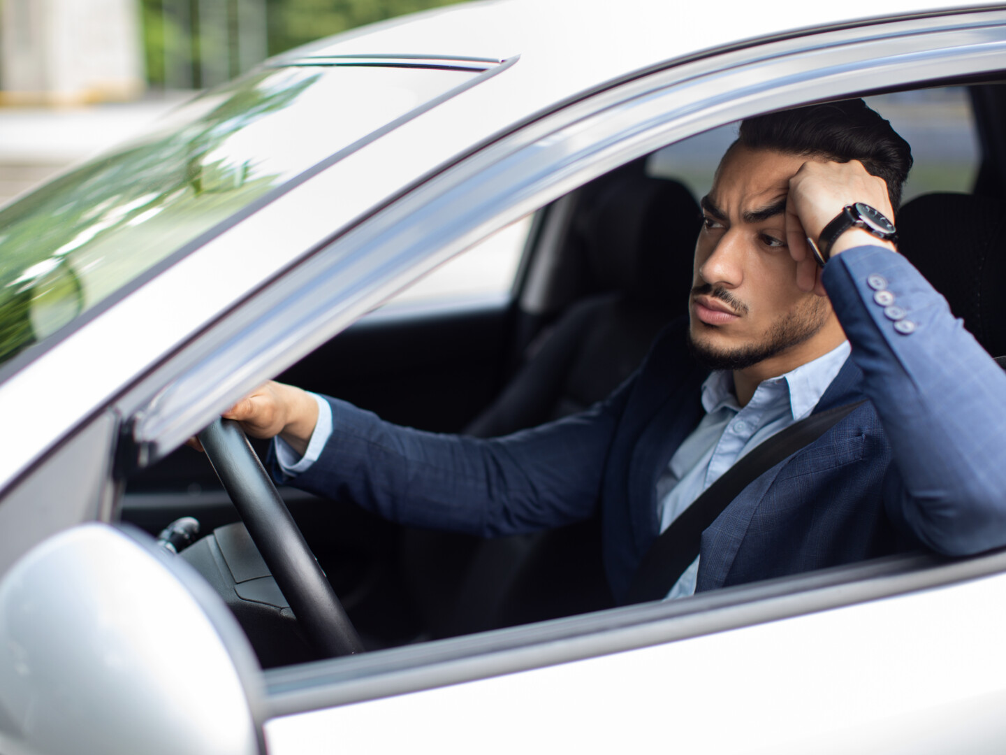 A frustrated employee stuck in traffic while on his way to work