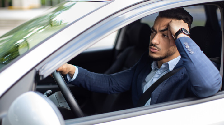 A frustrated employee stuck in traffic while on his way to work