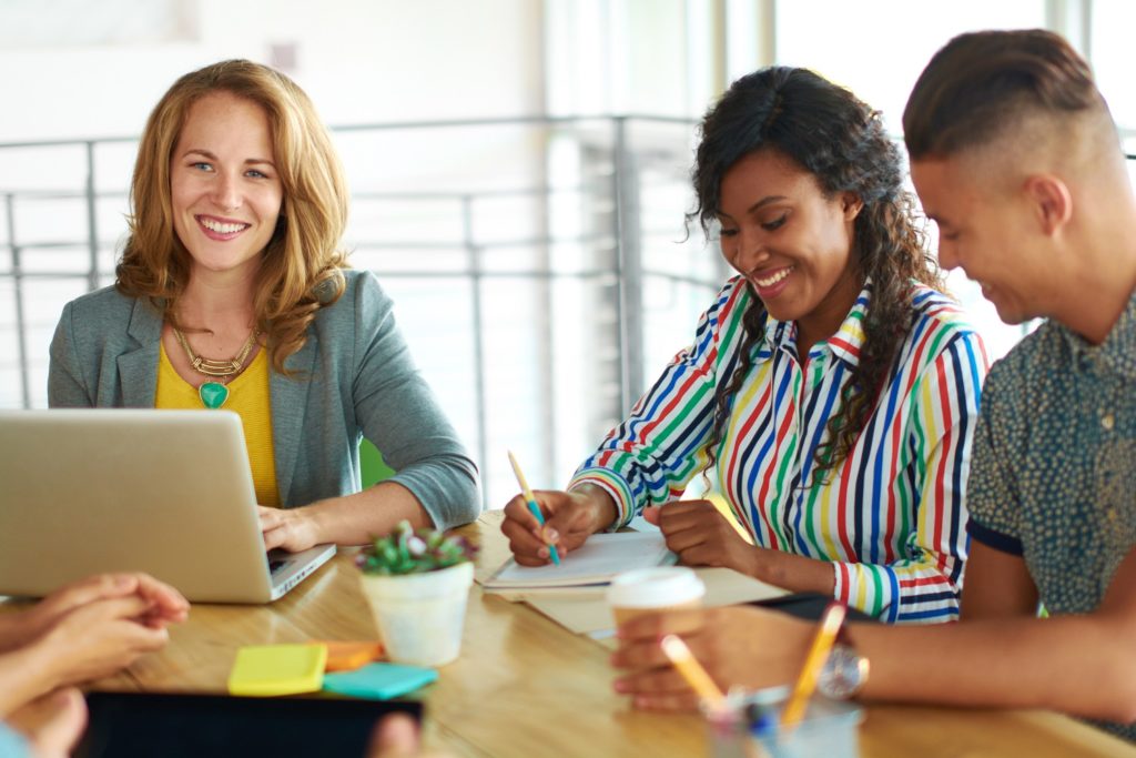 Candid image of a group with successful business people caught in an animated brainstorming meeting