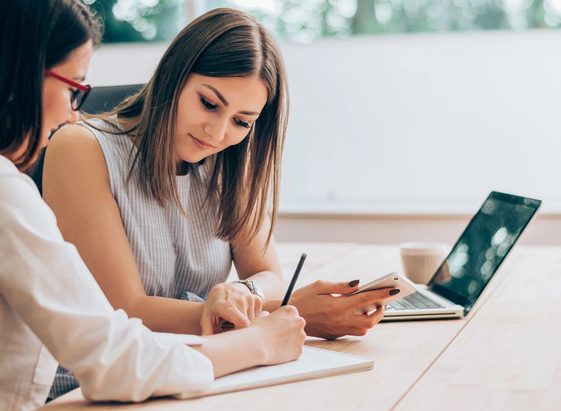 health and safety business partner subscriptions right image of two women collaborating at work