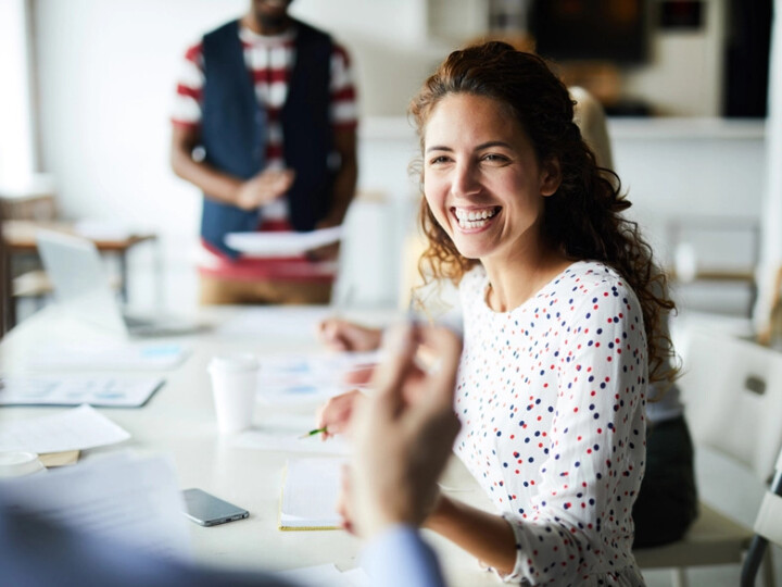 health and safety business partner subscription hero image of a woman at an informal meeting in an office
