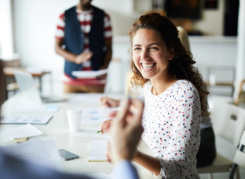health and safety business partner subscription hero image of a woman at an informal meeting in an office