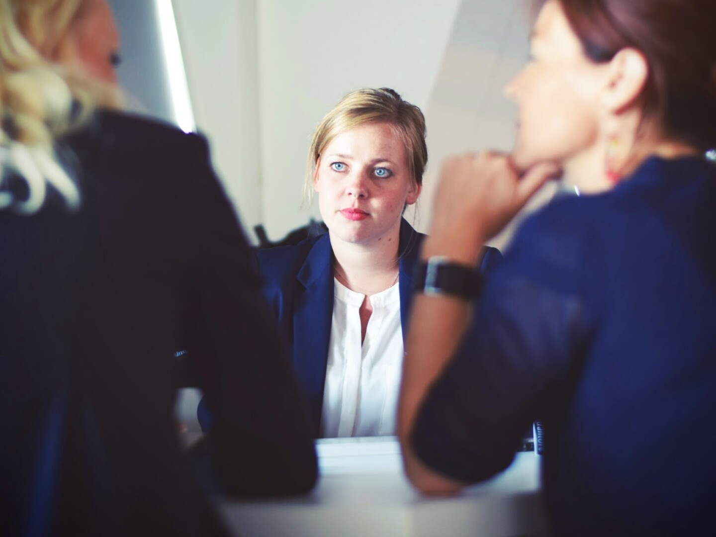 Navigating Redundancy: Guide for Employers image of a woman talking to two other women on each side of the table