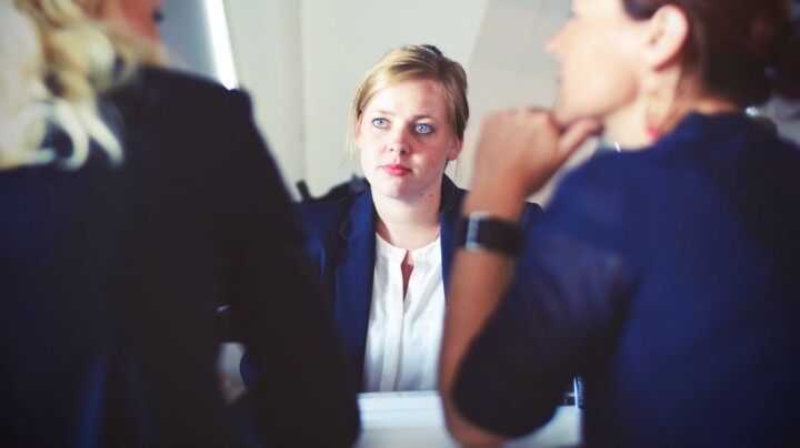 Navigating Redundancy: Guide for Employers image of a woman talking to two other women on each side of the table
