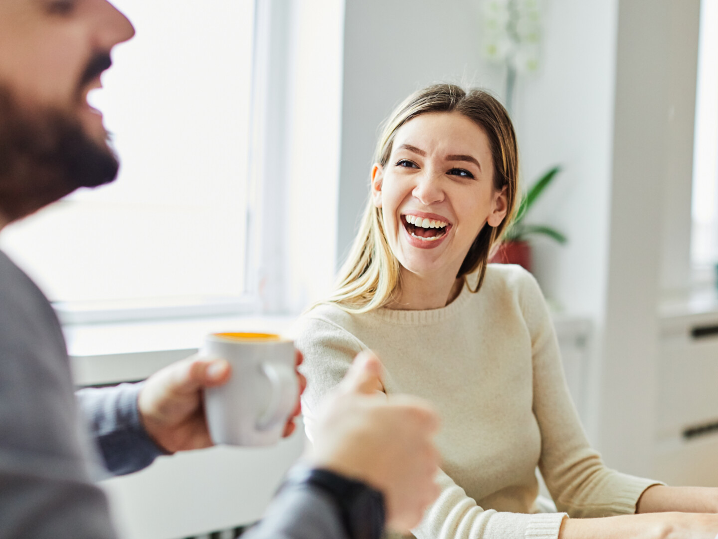 A young businesswoman smiling and talking to a male colleague