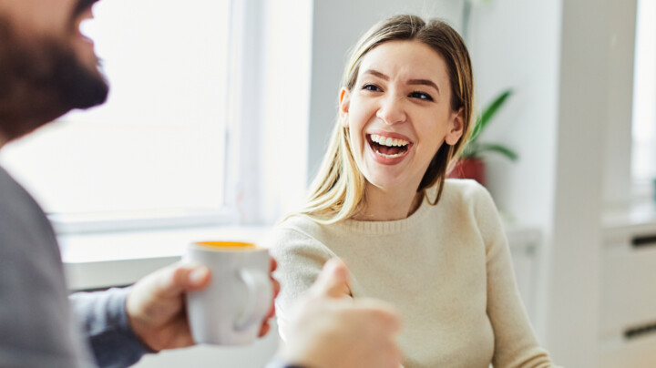 A young businesswoman smiling and talking to a male colleague