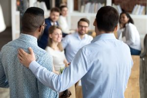 An employee being introduced to or praised others in the office.