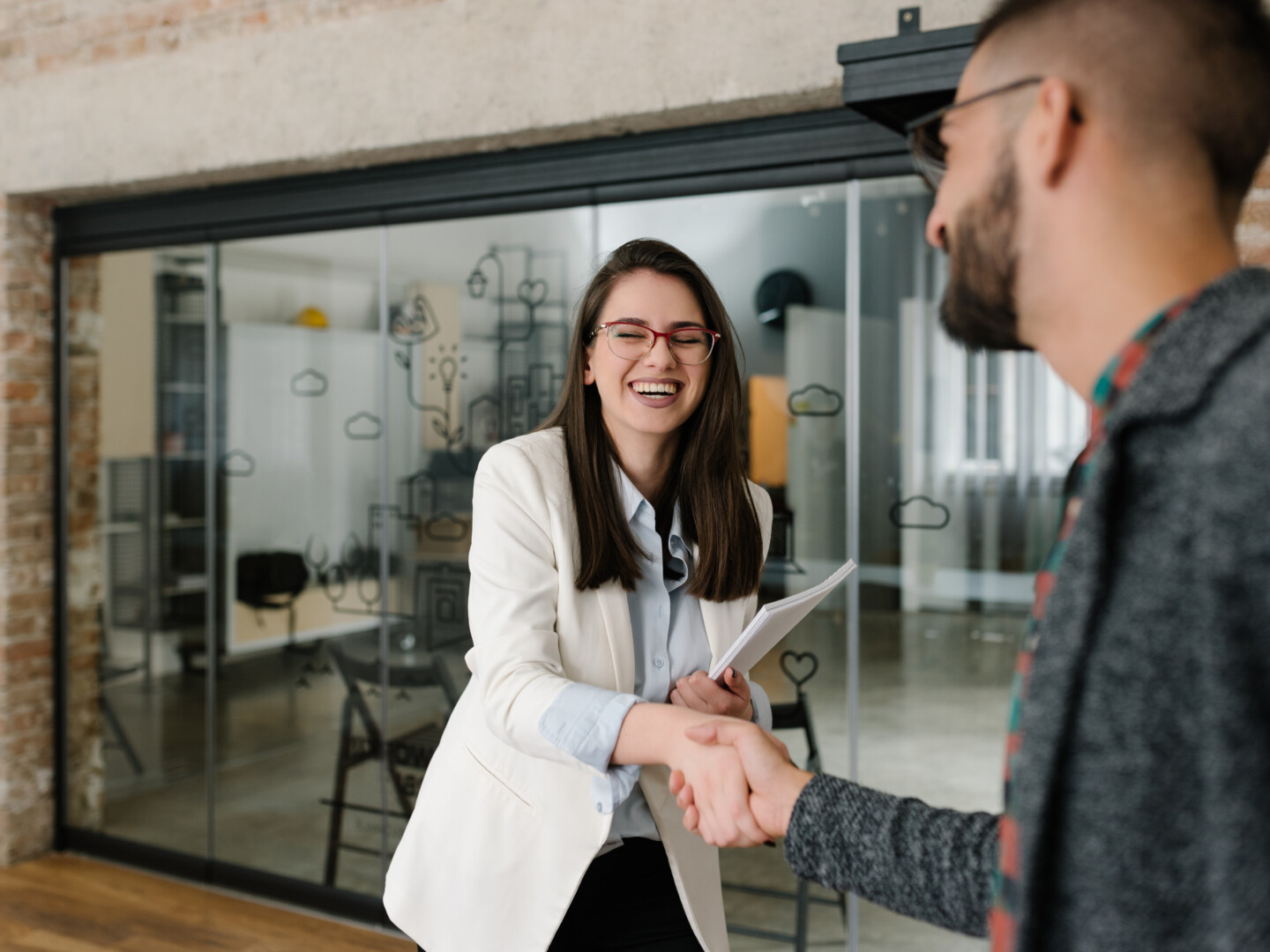 Handshaking and smiling candidly at a job interview