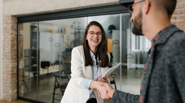 Handshaking and smiling candidly at a job interview