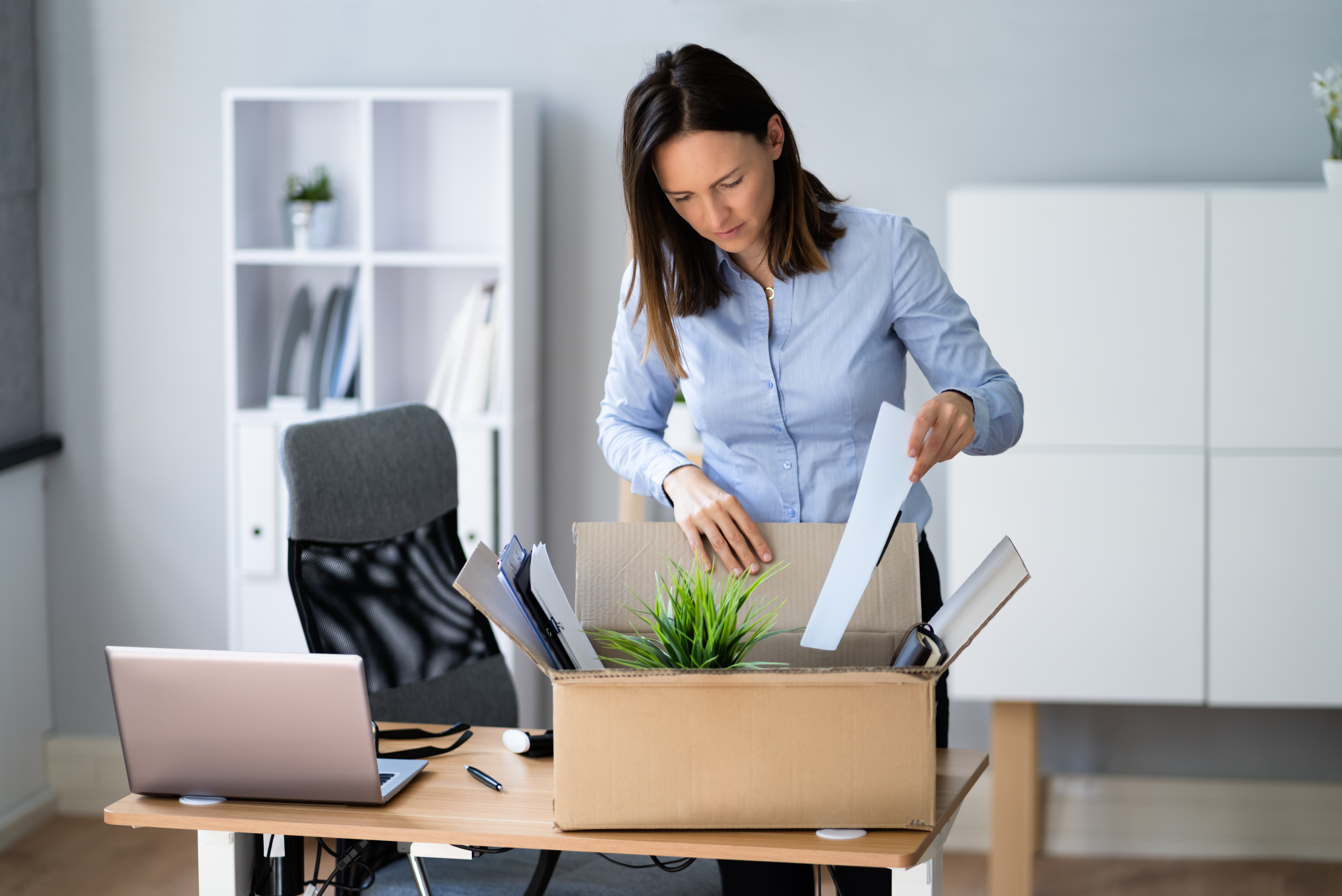 Female employee packing all her things to move out