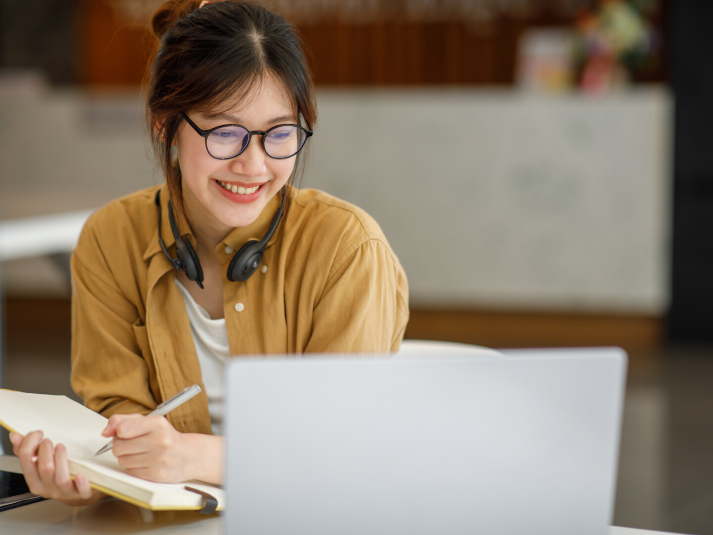 A happy young female employee working from home