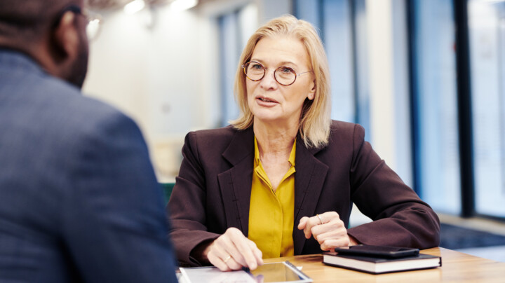 Mature female employee in discussion with a male employee