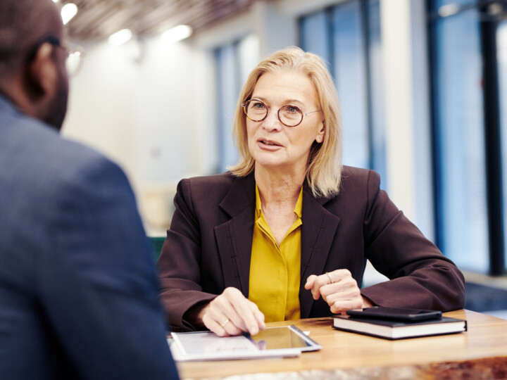 Mature female employee in discussion with a male employee