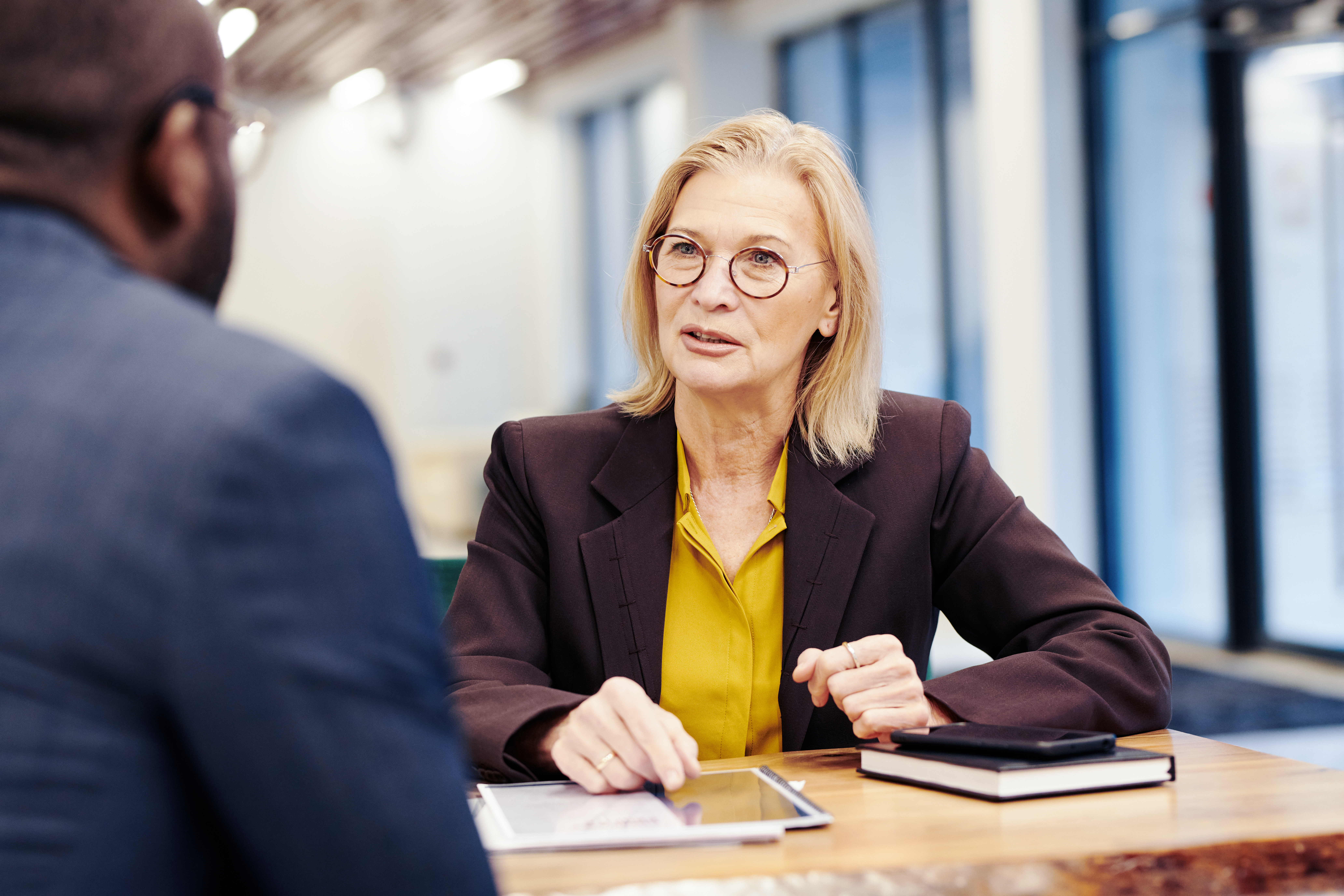 Mature female employee in discussion with a male employee