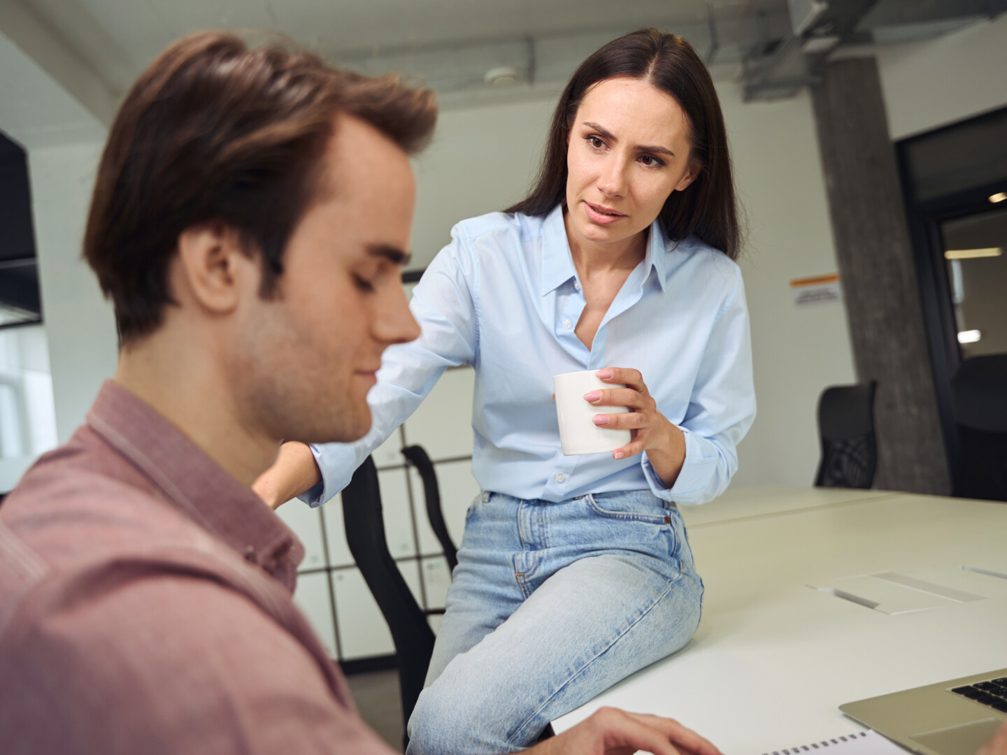 Female employee checking in on male employee