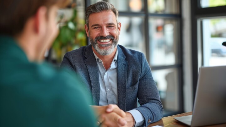 Happy matured businessman in a meeting