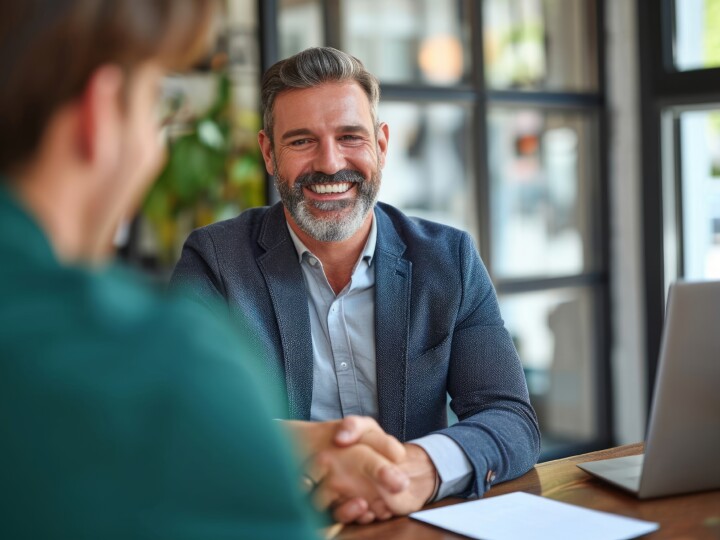 Happy matured businessman in a meeting